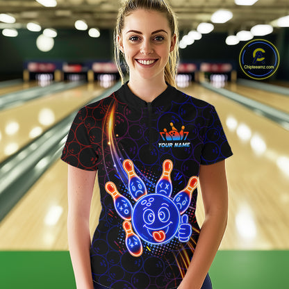 Woman wearing of a black bowling quarter zip shirt with neon blue and orange cartoon bowling ball and pin graphics, plus custom player name text.