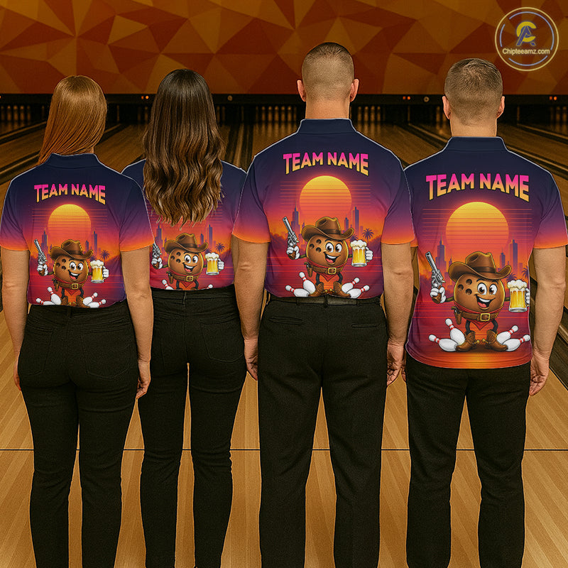 Four people standing with their backs to the camera in a bowling alley, wearing matching dark blue short-sleeve shirts with a large colorful graphic print on the back. The print features a cartoon bear wearing a cowboy hat, a sunset, bowling pins, and the text 'TEAM NAME'.