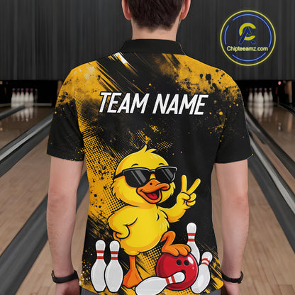 A person viewed from behind wearing a black and yellow bowling-themed custom shirt with a cartoon duck graphic and 'TEAM NAME' text, standing in a bowling alley. A circular 'Chipteeamz.