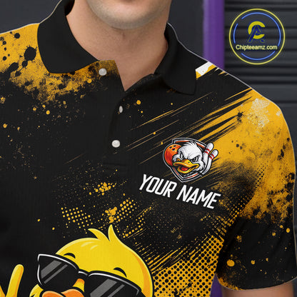 A close-up of a person wearing a black and yellow polo shirt with a custom cartoon duck graphic, the text 'YOUR NAME', and a circular 'Chipearnz.com' logo on the upper chest.