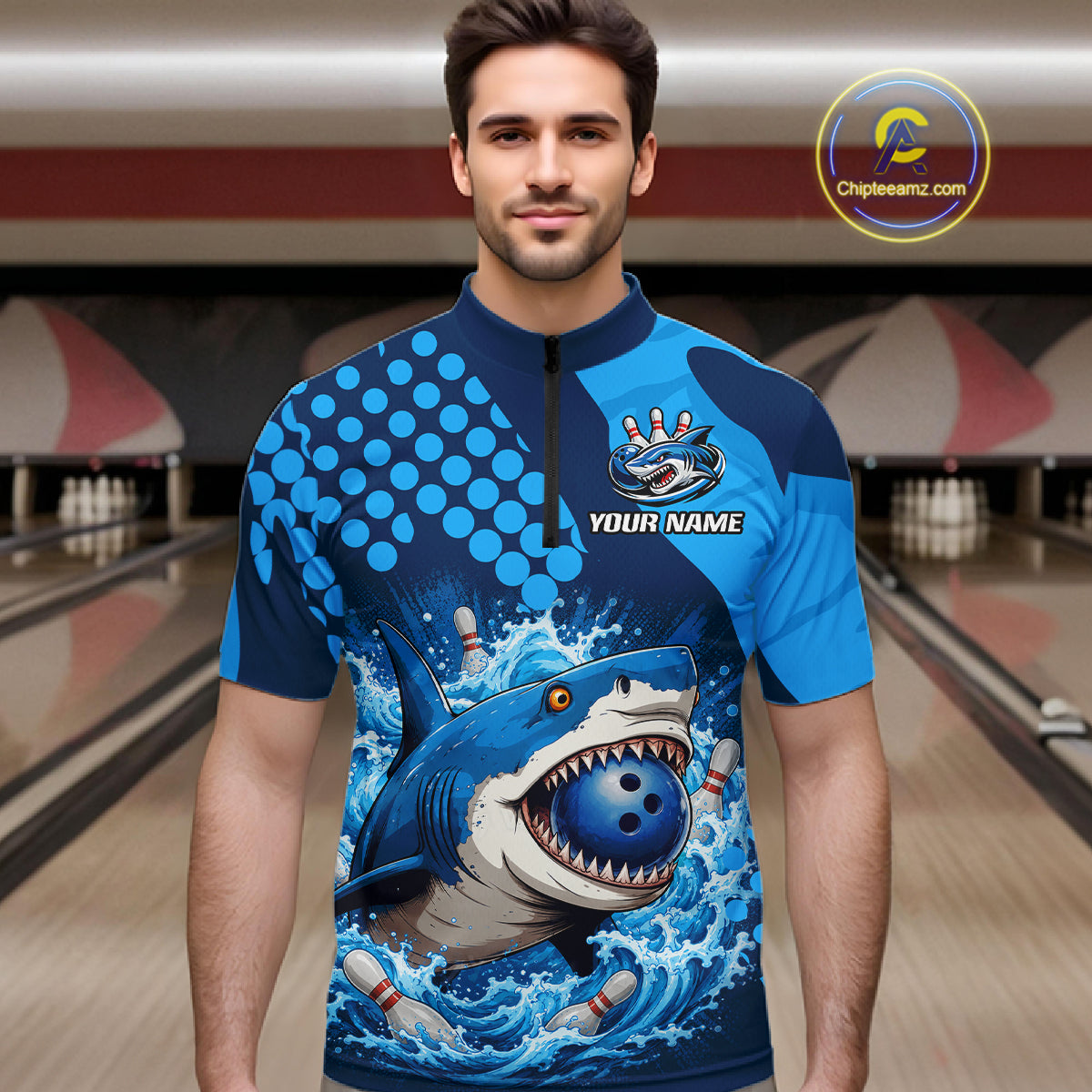 Man wearing a blue and navy bowling shirt with shark design in a bowling alley.