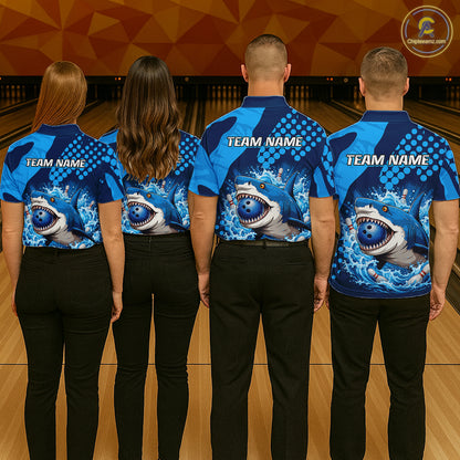 Four people wearing blue bowling shirts with shark graphics and 'Team Name' text in a bowling alley.