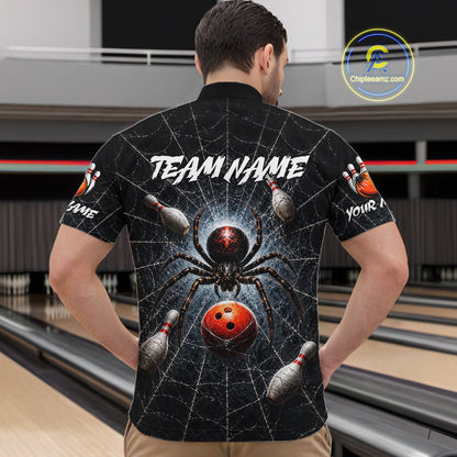 A man viewed from behind wearing a black short-sleeve bowling-themed shirt with a large spider and bowling ball graphic on the back, standing in a bowling alley.
