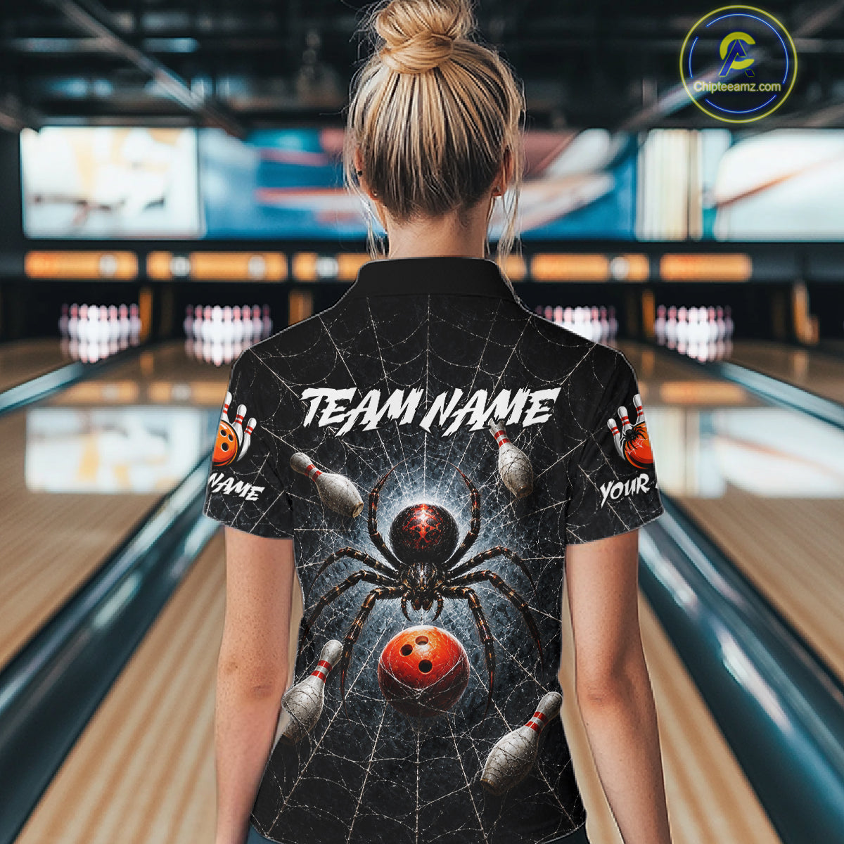 Person wearing a black shirt with a gold cobra design and 'TEAM NAME' text in a bowling alley.