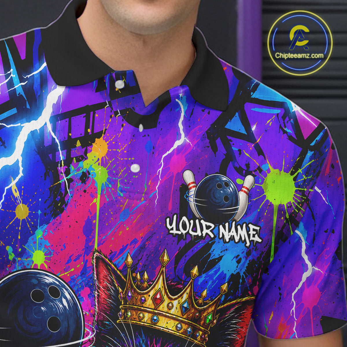 Personalized bowling polo shirt with a crowned cat holding a bowling ball, blended with colorful paint strokes and graphic patterns.