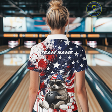Load image into Gallery viewer, Women’s us flag raccoon bowling polo shirt, back view on female model in bowling lane 