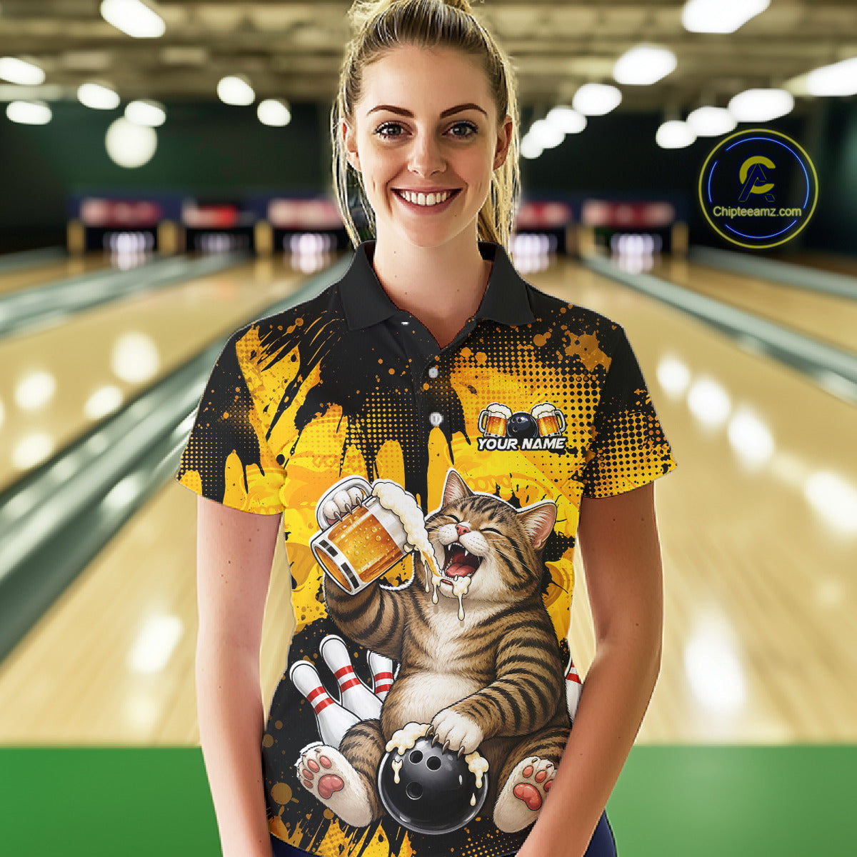 Woman wearing a colorful bowling-themed shirt with a cat design in a bowling alley.