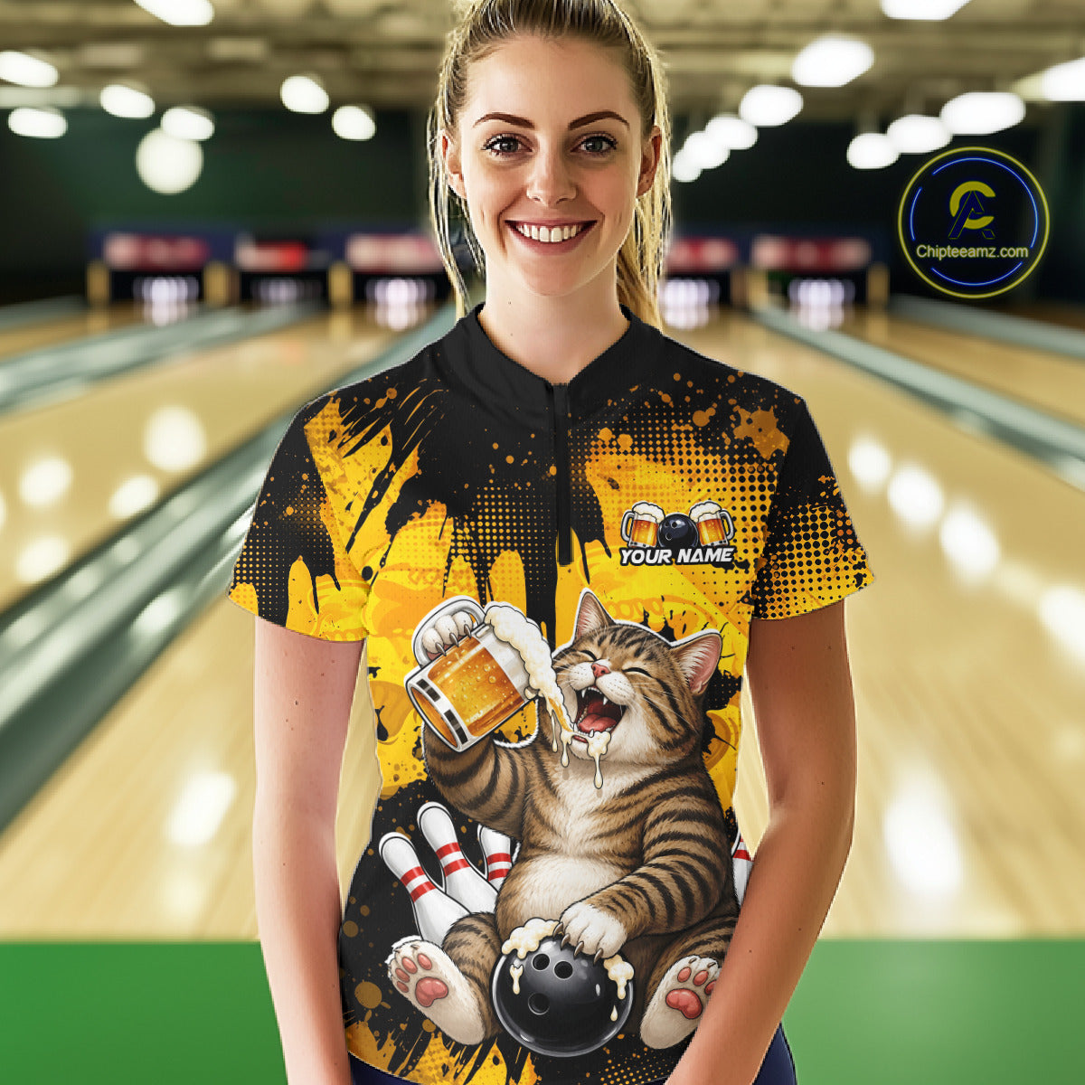 Person wearing a colorful bowling shirt with a cat design in a bowling alley.