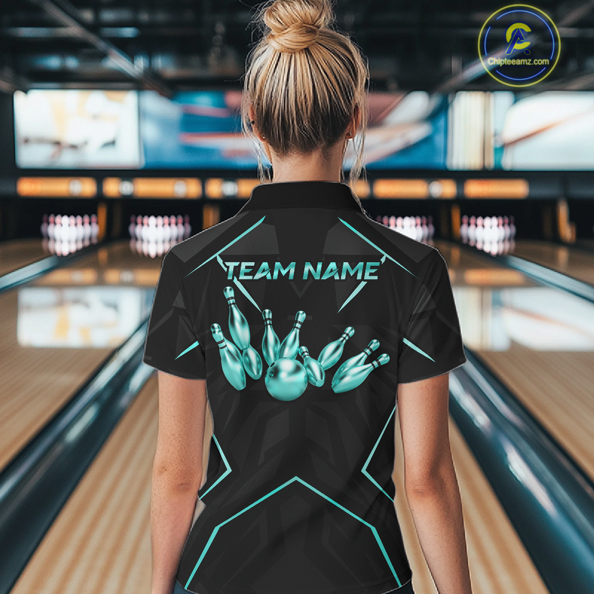 Person wearing a black bowling shirt with teal graphics and 'TEAM NAME' text in a bowling alley.
