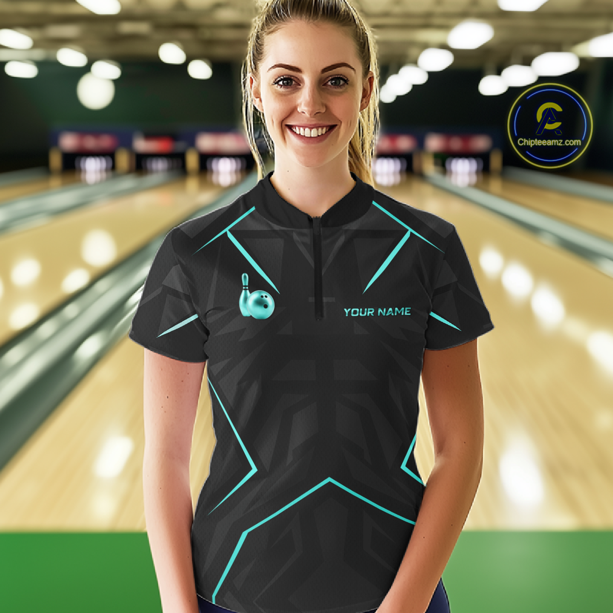 Woman wearing a black bowling shirt with teal accents in a bowling alley.
