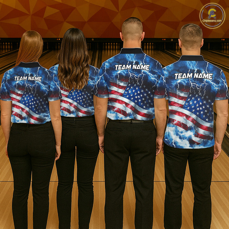 Four people standing with their backs to the camera in a bowling alley, wearing matching custom bowling shirts with a blue lightning and American flag design. The shirts have 'TEAM NAME' printed on the back.
