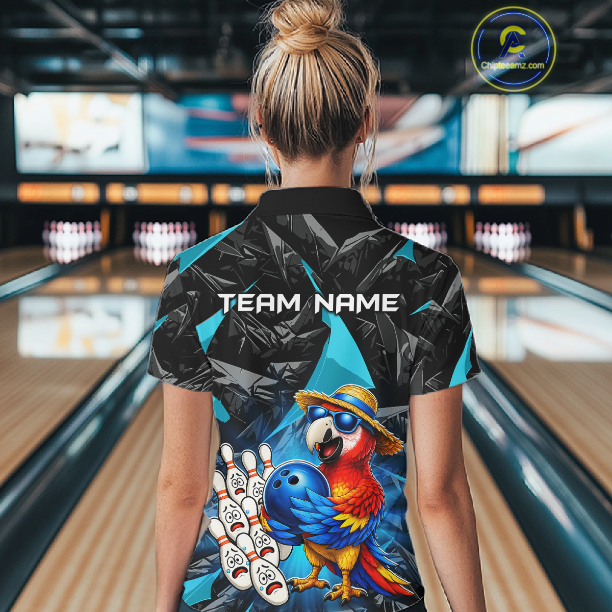 Person wearing a bowling shirt with a parrot design and 'Team Name' text in a bowling alley.