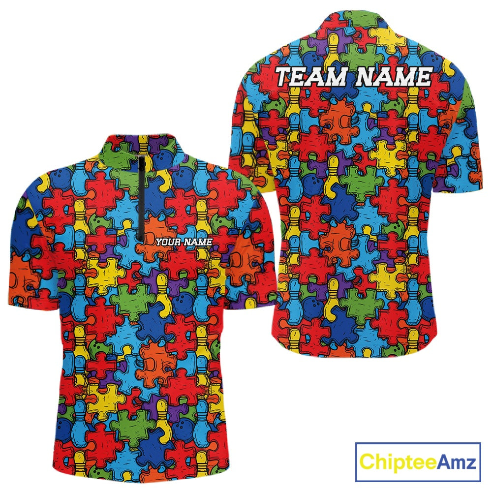 Front and back views of a short-sleeve quarter zip shirt featuring a colorful puzzle piece pattern in red, blue, yellow, and green. The front has a dark zipper at the collar and the text 'YOUR NAME' printed on the chest, while the back has 'TEAM NAME' printed across the shoulders.