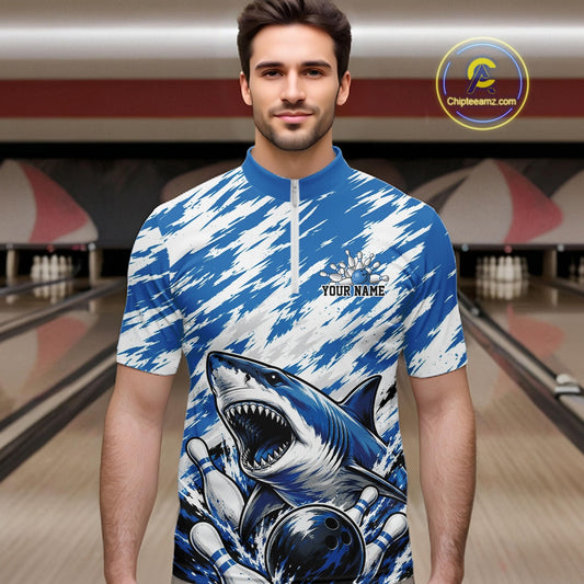 Man wearing a blue and white sports jersey with a shark design in a bowling alley.