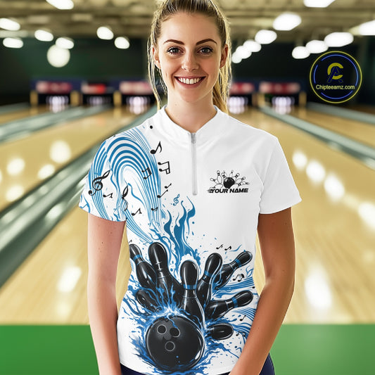 Female model in a white and blue bowling quarter-zip shirt at the lane with bowling-themed graphics and flowing musical accents.