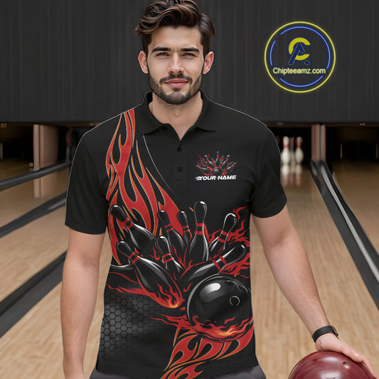 Front view of a male model in a bowling lane wearing a black polo shirt with red flaming black bowling ball striking pins and energetic sports styling.