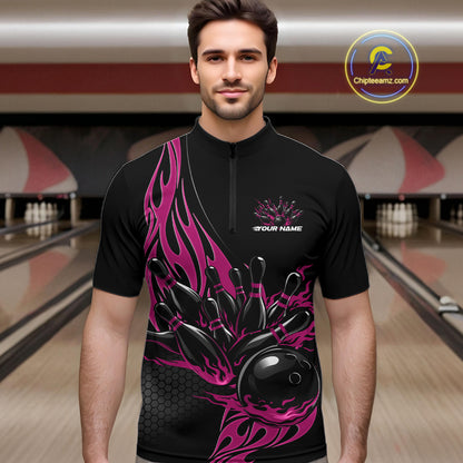 Male model front view in bowling lane wearing black quarter zip shirt with pink flaming bowling ball striking pins in vibrant athletic design.
