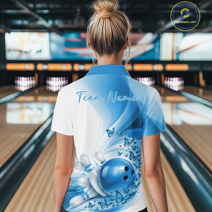 Back view of a female model wearing a white and blue bowling quarter zip with butterfly artwork and bowling graphics
