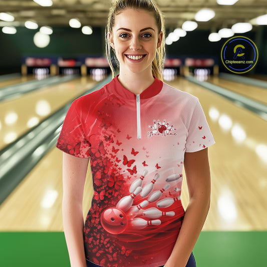 Woman wearing a red and white butterfly bowling shirt with a design on a bowling alley background