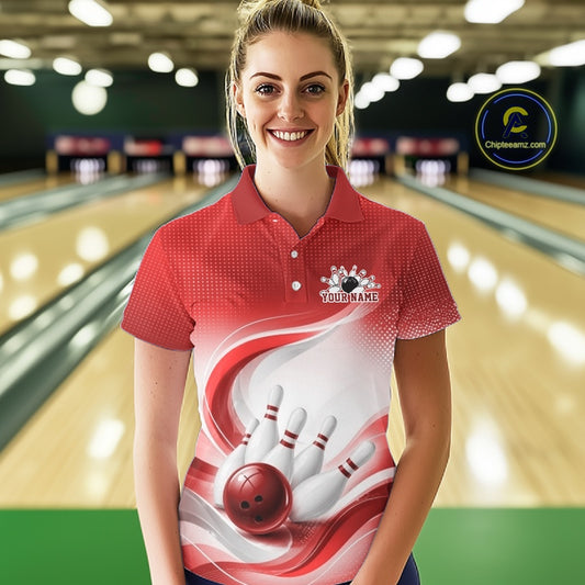 Female model wearing a white and red bowling polo shirt with graceful wave patterns and a bowling strike graphic inside a bowling center