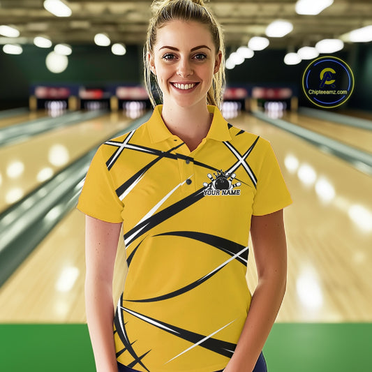 Front view of a female bowler wearing a yellow, black, and white bowling polo shirt in a bowling lane