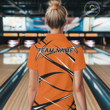 Load image into Gallery viewer, Back view of a female model in a bowling alley wearing an orange, black, and white bowling quarter zip shirt with a sporty jersey design