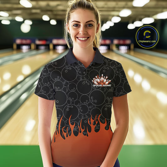 Front view of a female model in a bowling lane wearing a black polo shirt with vibrant orange flames and bowling ball pattern in a dynamic flaming bowling action design.