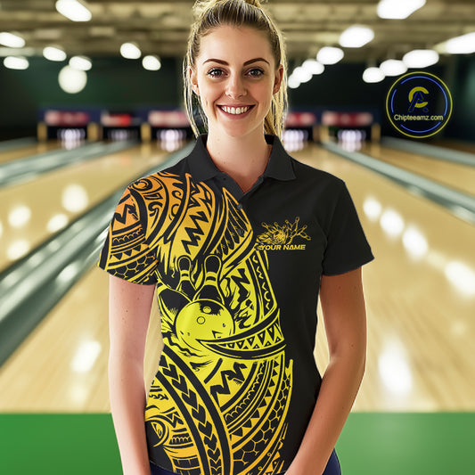Female model wearing a black and gold bowling polo shirt at the lane with Polynesian-style bowling details.