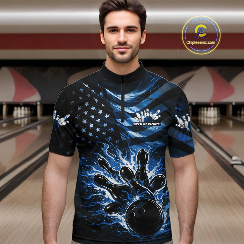 Male model wearing a black bowling quarter-zip shirt at the lane with blue flame bowling artwork and flag-inspired elements.