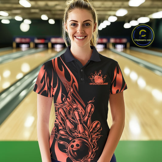 Female model front view in bowling lane wearing black polo shirt with red gradient tribal flame bowling ball hitting pins in energetic action scene.