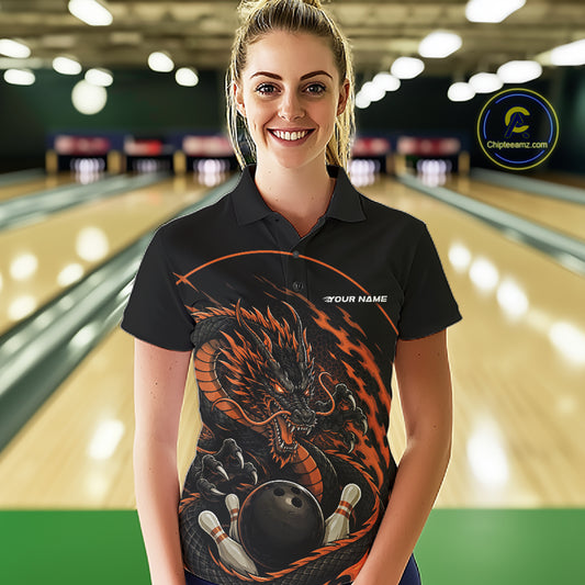 Front view of a female model in a bowling alley wearing an orange custom bowling polo shirt featuring an aggressive dragon with flames in a dynamic and energetic design.