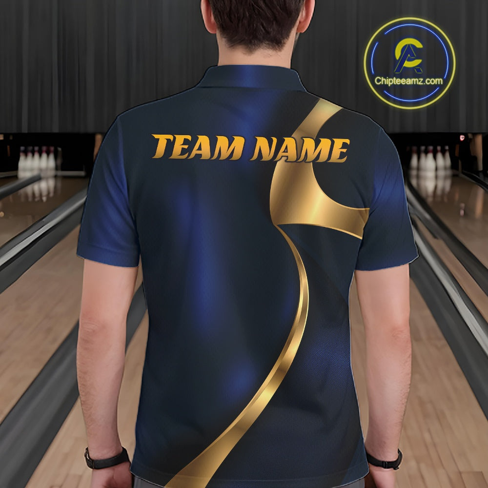 A man viewed from behind wearing a dark navy blue bowling shirt with a metallic gold graphic design and 'TEAM NAME' printed across the upper back. Bowling lanes are visible in the background