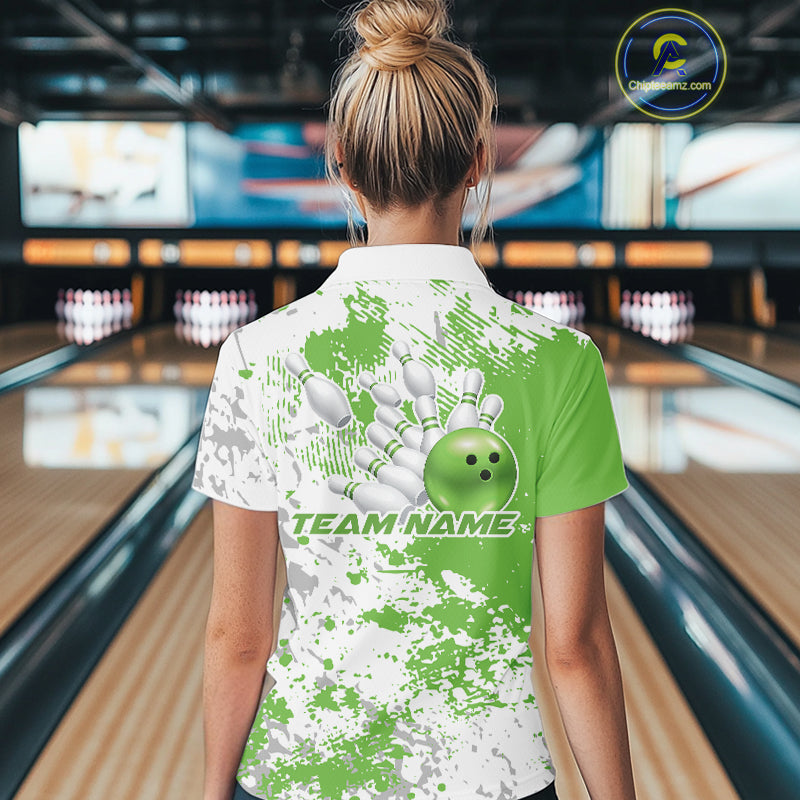 Back view of a female model in a bowling lane wearing a green and white splatter bowling quarter-zip shirt with simple sporty bowling graphics.