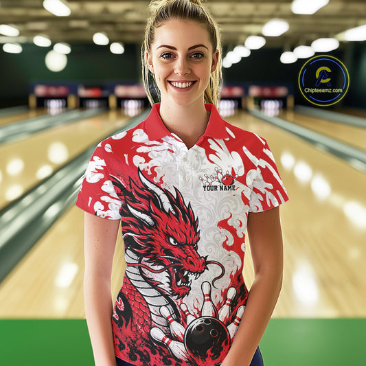 Woman wearing a red and white dragon-themed bowling shirt in a bowling alley.