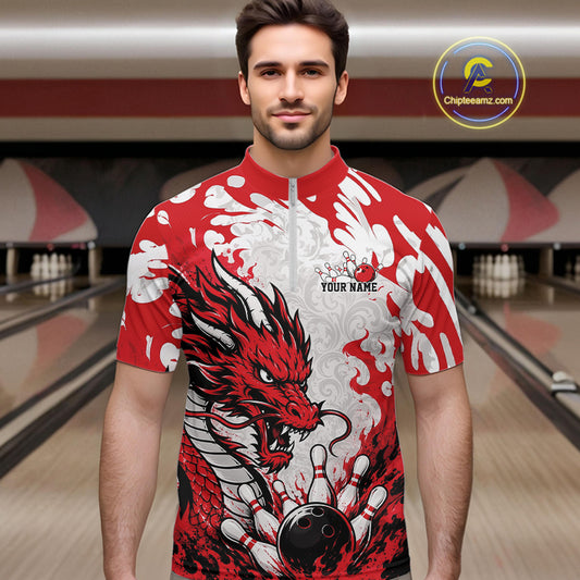 Man wearing a red and white dragon-themed bowling shirt in a bowling alley.