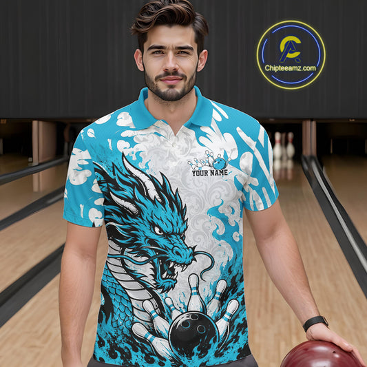 Man wearing a blue and white dragon-themed bowling shirt in a bowling alley.
