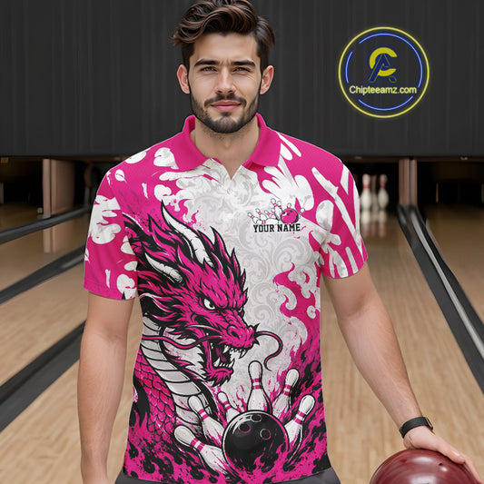 Man wearing a pink and white dragon-themed bowling shirt in a bowling alley.