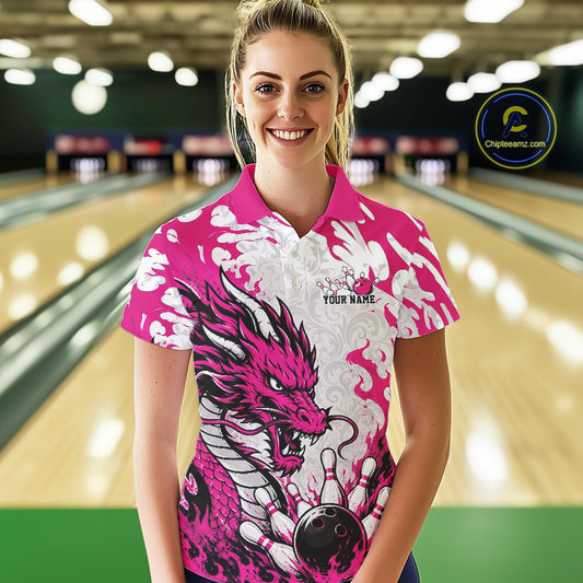 Woman wearing a pink and white bowling shirt with a dragon design in a bowling alley.