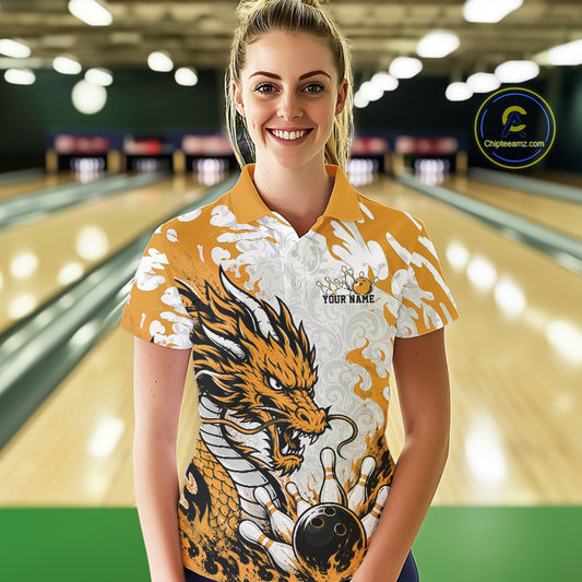Woman wearing a bowling shirt with a dragon design in a bowling alley.