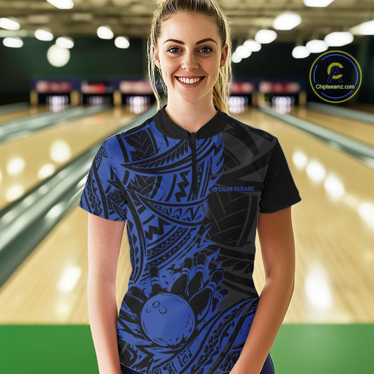 Woman wearing a blue and black tribal pattern bowling shirt with a bowling alley in the background