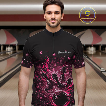 Male model wearing a black and pink bowling quarter-zip shirt at the lane with flaming bowling ball artwork.