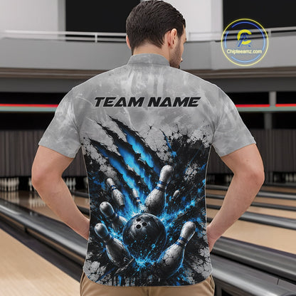 Front view of a male model wearing a gray bowling quarter zip shirt featuring a dramatic blue bowling ball and pins graphic with claw-mark artwork in a bowling lane.