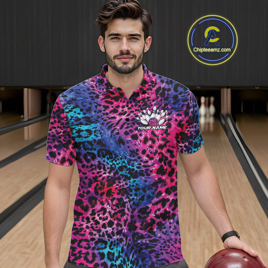 A man stands in a bowling alley wearing a yellow, brown, and black leopard-print bowling shirt with a bowling pin graphic and “Your Name” on the chest.