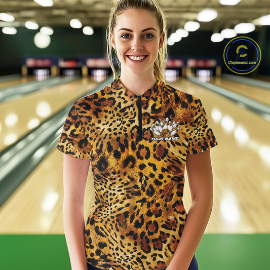 Woman in a bowling alley wearing a leopard print women's quarter zip shirt with a customizable text