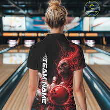 Load image into Gallery viewer, Back view of a female model in a bowling alley wearing a black bowling quarter zip shirt featuring a red fiery skull with lightning striking a bowling ball and pins and a custom name.
