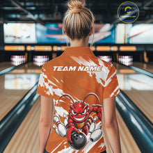 Load image into Gallery viewer, Back view of a female model in a bowling alley wearing an orange custom bowling polo shirt with an aggressive crawfish bowling design and a distressed background.