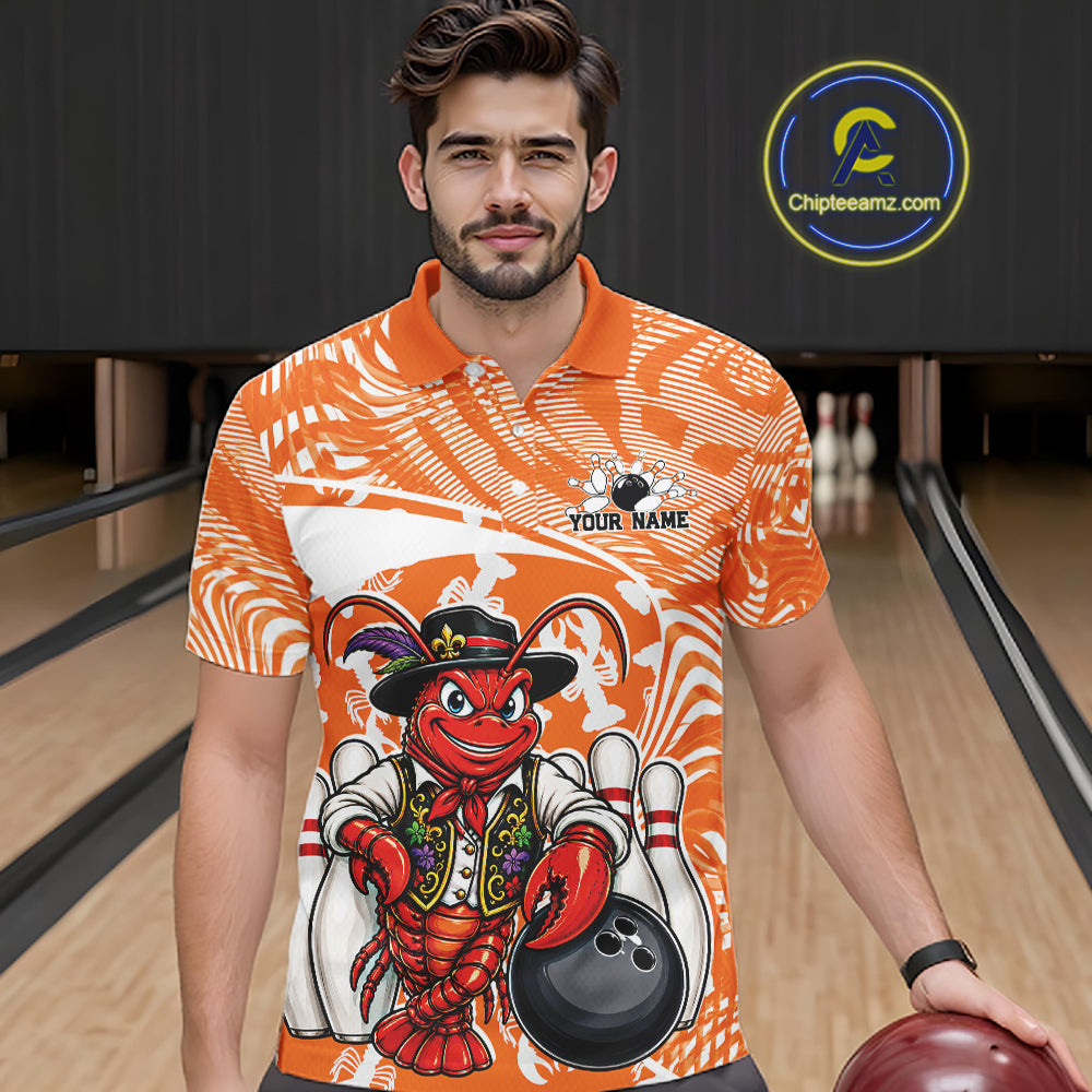 Front view of a male model in a bowling alley wearing an orange custom bowling polo shirt with a funny Cajun crawfish leaning on a bowling ball and a swamp inspired texture background.