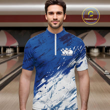 Load image into Gallery viewer, Front view of a male bowler wearing a white and blue bowling quarter-zip shirt with a splatter-inspired sports jersey design in a bowling lane