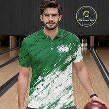 Load image into Gallery viewer, Front view of a male bowler wearing a white and green bowling polo shirt with a splatter-inspired sports jersey pattern in a bowling lane