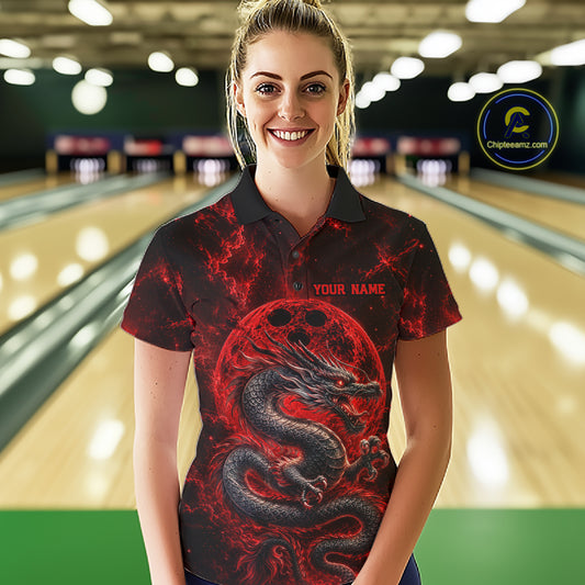 Front view of a female model in a bowling alley wearing a red custom bowling polo shirt featuring an ancient dragon, flames, and a moon-inspired bowling ball design.